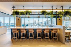 a large kitchen with a large island with bar stools at Hilton Garden Inn Yokohama Minatomirai in Yokohama