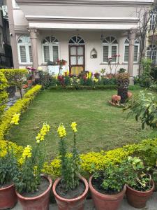 a house with flowers in front of a yard at L&S apartment in Kathmandu