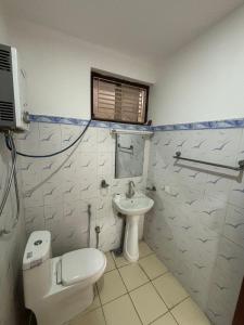 a bathroom with a white toilet and a sink at L&S apartment in Kathmandu +10 photos
