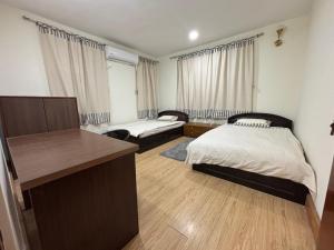 a bedroom with a bed and a desk in it at L&S apartment in Kathmandu
