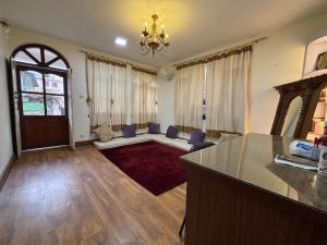 a large living room with a chandelier and a table at L&S apartment in Kathmandu