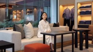 a woman standing in front of a furniture store at Anook Resort & Spa Busan Haeundae in Busan +284 photos