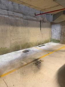 a concrete room with a yellow line on the floor at Suite bike with parking in Trieste