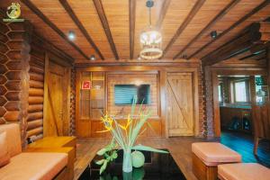 a living room with wood paneling and a table with a plant at Ume Villa & Retreat in Bóng Suối