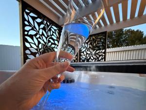 a person is holding a glass of water at The Nook in Greytown