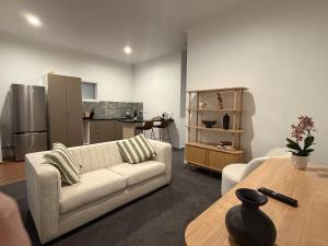 a living room with a couch and a table at The Nook in Greytown