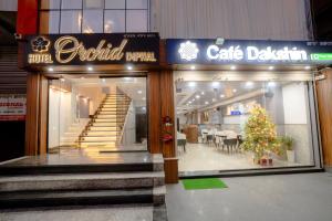 a store front with a christmas tree in the window at Hotel Orchid Imphal in Imphal
