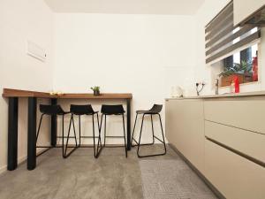 a kitchen with a table and stools in a room at Wanderlust 2 in Sliema