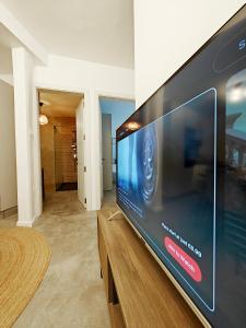 a large flat screen tv sitting on top of a wooden table at Wanderlust 2 in Sliema