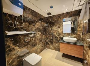 a bathroom with a sink and a mirror at Hotel Plaza 14 Jammu, Near Railway Station in Jammu