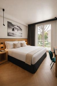 a bedroom with a large bed and a large window at View Place & Spa in Numana