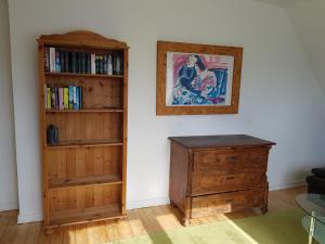 a room with a book shelf and a wooden dresser at Ferienwohnung Martino in Simmern