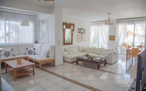 a living room with white couches and a table at Casa Bianca - Good Living in Preveza +35 photos