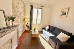 a living room with a couch and a fireplace at Old Antibes 1 Bedroom 4 Persons in Antibes