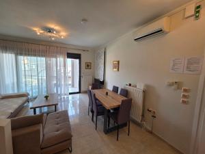 a living room with a table and chairs and a couch at Venetia Luxurious Villa in Iraklitsa