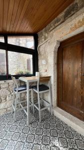 a table and chairs in a room with a door at SİSU ALAÇATI OTEL in Çeşme +47 photos