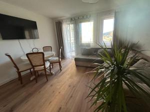 a living room with a table and a couch at An der Elbe in Bad Schandau