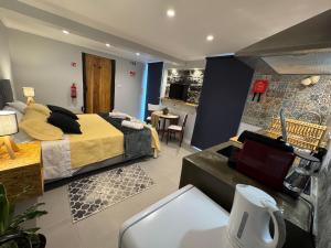 a bedroom with a bed and a living room at Refúgio do Nevoeiro Estudio in Porto Moniz