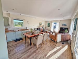 a kitchen and living room with a table and chairs at KRAB160 in Sint Annaland