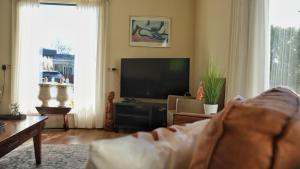 a living room with a couch and a flat screen tv at KRAB160 in Sint Annaland +25 photos