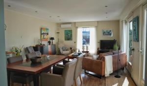 a living room with a dining table and a couch at KRAB160 in Sint Annaland