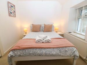 a bedroom with a bed with towels on it at 27 Kingshead Street in Pwllheli