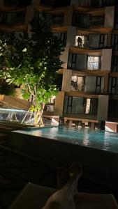 a building with a swimming pool in front of it at quintara arte 52,on nut in Bangkok