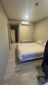 a bedroom with a bed and a chair in it at quintara arte 52,on nut in Bangkok +6 photos