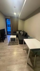 a living room with a couch and a table at quintara arte 52,on nut in Bangkok