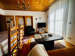 a living room with a table and a couch at Ferienwohnung "Korte" in Rechlin