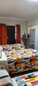 a hotel room with two beds in a room at Marli Guesthouse Self-Catering in Welkom