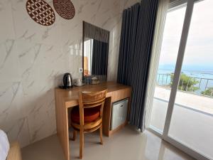 a desk in a bedroom with a view of the ocean at Prasi Sunrise Sea View in Nusa Penida
