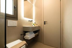 a bathroom with a sink and a mirror at Aether-Castle vista in Monemvasia +15 photos