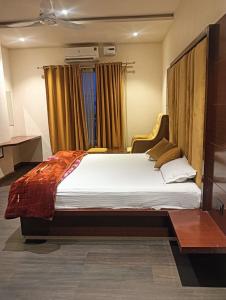 a bedroom with a large bed in front of a window at Narayan resort and restaurant in Aklera