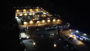 a building with lights in a parking lot at night at The Hill Glamping in Yeoju