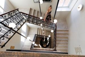 a woman is standing on the stairs of a house at Jadran Heritage Hotel, Valamar Collection in Poreč +23 photos