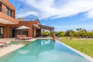 a swimming pool in front of a house at Citrus Bloom Manor Marrakech in Oulad Mazoug