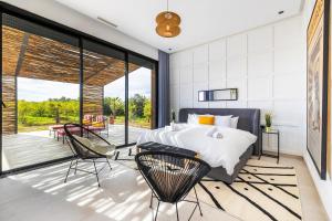 a bedroom with a bed and a patio at Citrus Bloom Manor Marrakech in Oulad Mazoug +55 photos