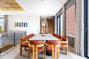 a dining room with a table and chairs at Citrus Bloom Manor Marrakech in Oulad Mazoug