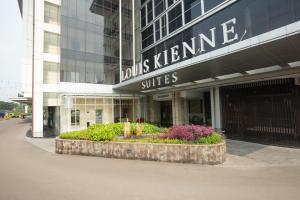 a building with a sign that reads louis kerkne suites at Louis Kienne Hotel Cikarang in Cikarang