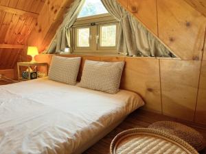 a bed in a small room with a window at Gapyeong Sol Stay Spa Pension in Gapyeong +6 photos
