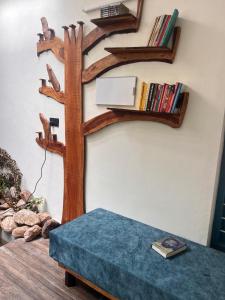 a living room with a book shelf and a bench at Kabani By Kallar in Trivandrum