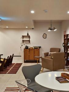a living room with a table and chairs at Jeonju Hotel Stay Bok-e in Jeonju
