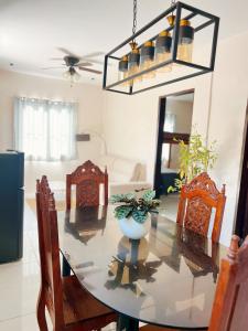 a dining room table with chairs and a vase on it at Lio house in El Nido