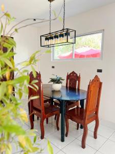a dining room with a blue table and chairs at Lio house in El Nido