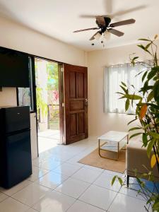 a living room with a ceiling fan and a couch at Lio house in El Nido