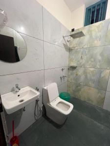 a bathroom with a toilet and a sink at Kabani By Kallar in Trivandrum +15 photos
