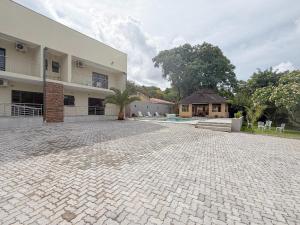 a large brick driveway in front of a building at Mevis Boutique Hotel in Bulawayo +4 photos