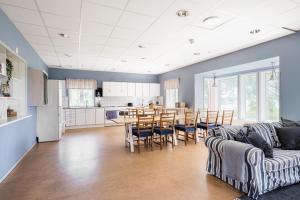 a kitchen and living room with a couch and a table at Lidö Värdshus in Lidö