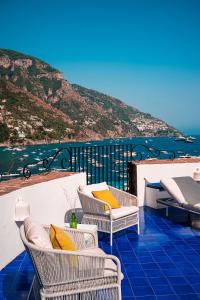 a balcony with chairs and a view of the ocean at Villa Torre Trasita luxury suites in Positano